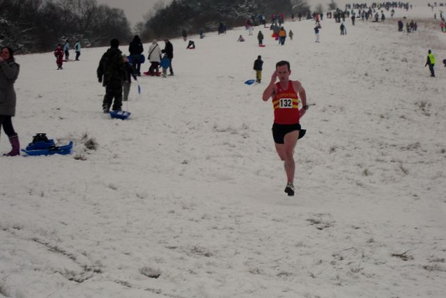 Harold Wyber strides home in shorts and vest among those sledging on Box Hill
